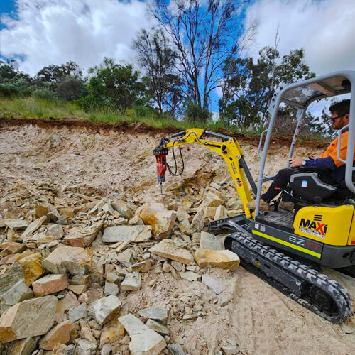 Maxi Equipment Hire - Excavator hire page image of Wacker Neuson 1.8 Ton Excavator with a rock breaker in action.