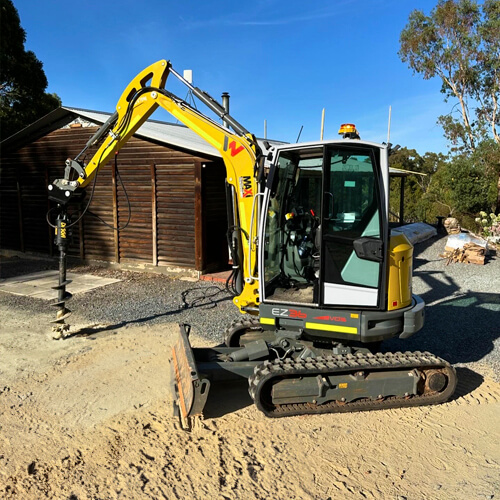 Maxi Equipment Hire - Excavator hire page image of Wacker Neuson 4.5 Ton Excavator with large auger attached.