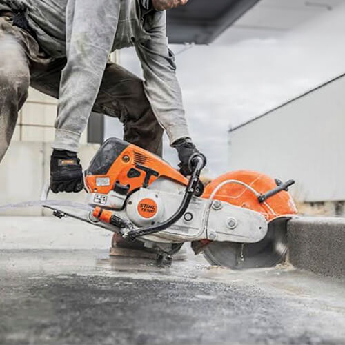 Maxi Equipment Hire - concrete cutting saw hire page close-up image of the saw in action cutting road curb.