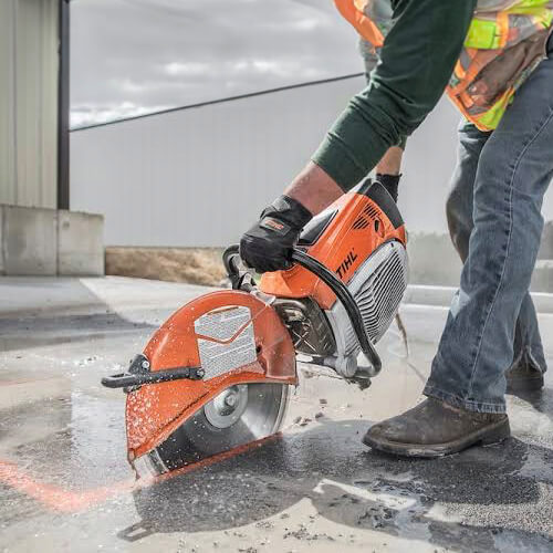 Maxi Equipment Hire - concrete cutting saw hire page close-up image of the saw in action cutting through concrete.